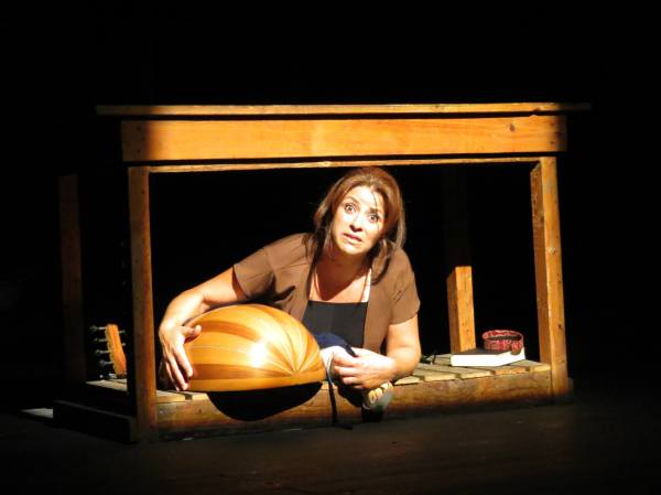 Roueida Ghali with an oud inside a wooden frame