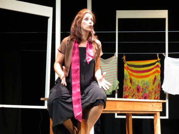 Roueida Ghali on stage among hanging laundry